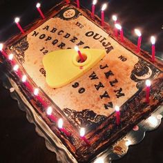 a birthday cake with candles on it and an object in the middle that says,