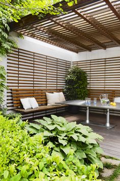 a wooden bench sitting under a pergolated roof