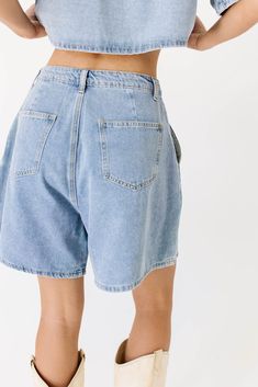 the perfect summer outfit exists, + it’s this iconic denim-on-denim moment. comprised of a boxy short sleeve denim top + matching pleated denim shorts, this casual two-piece set serves some serious 90s nostalgia. whether worn together or separately, it’s a set you can count on to slay the day. light denim // collared, buttons, cropped, front breast pocket, high waisted, one button fly zip, belt loops, pockets, pleat detailing model is 5'8" + wearing a small measurements are approximate + taken w 90s Inspired Denim Jean Shorts For Spring, Oversized Washed Blue Bottoms For Summer, Oversized High Rise Bottoms For Summer, 90s Inspired Denim Jean Shorts For Summer, 90s Inspired Jean Shorts For Summer, Oversized Dark Wash Bottoms For Summer, 90s Inspired Denim Summer Bottoms, 90s Inspired Denim Shorts, 90s Inspired Denim Jean Shorts