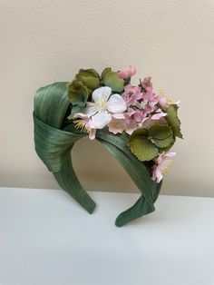 One of kind unique fascinator headband.  Stand out from the crowd in this stunning handmade sculptural large side knot crafted from Premium silk Abaca in olive green with complementary hydrangea, blossom and small flowers in pink and olive. A sculptural piece with hand stitched finish for longevity.   FIT and SIZE A flexible base band to fit all head sizes.  PACKAGING Each headband is wrapped in pretty acid free tissue paper, sealed with an Evierosemade brand sticker and shipped in an eco-friend Green Fascinator With Handmade Flowers For Party, Green Handmade Flowers Fascinator For Spring, Olive Green Fascinator, Spring Adjustable Green Fascinator, Luxury Green Summer Fascinator, Headband Stand, Unique Fascinators, Green Fascinator, Brand Stickers