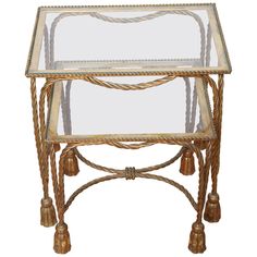 a glass and metal end table with rope