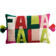 a colorful pillow with the word fala on it and tasselled fringes