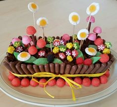 a cake decorated with flowers and eggs on a plate