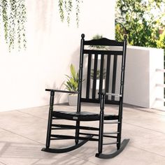 a black rocking chair sitting on top of a patio