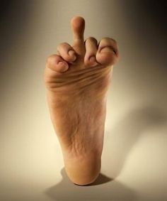 a person's foot is shown with their fingers in the air