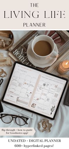 the living life planner is displayed on a tablet with glasses and other items around it