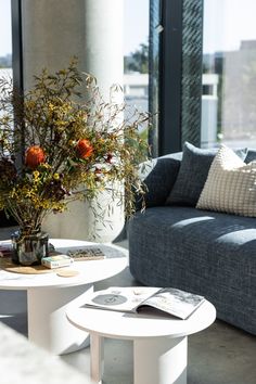 a living room with two couches and a coffee table in front of large windows