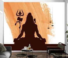 a living room with a couch, coffee table and wall mural depicting the silhouette of a person meditating in yoga position