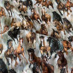 a group of horses running across a field next to each other on a sheet that is covering the ground