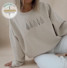 Embroidered Pine Tree Sweatshirt, Embroidery Christmas Tree Hoodie, Christmas Kids Sweatshirt, Xmas Tree Sweatshirt, Pine Tree Hoodie ---------- Product ---------- * Heather CVC Colors: 50% cotton, 50% poly, * Plain colors:100% cotton * Rolled sleeves in pictures is for styling purposes only. * Colors may seem different on the computer screen, or in the lighting in which the picture was taken. * Each item is sold separately. * Double-needle stitching throughout * Seamless collar * We use direct Embroidered Long Sleeve Christmas Sweatshirt, Winter Hoodie With Crew Neck And Machine Embroidery, Long Sleeve Tops With Machine Embroidery For Winter, Embroidery Christmas Tree, Christmas Tree Hoodie, Sweatshirt Embroidery, Embroidery Christmas, Christmas Kids, Rolled Sleeves