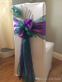 a chair decorated with purple, green and blue ribbons for a wedding or special event