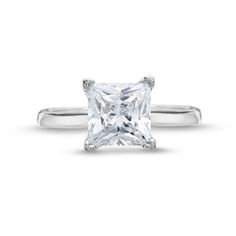 a princess cut diamond ring on a white background