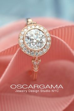 an image of a diamond ring on a pink cloth with the words oscarama jewelry design studio nyc