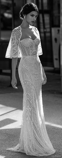 a woman in a long dress walking down the street