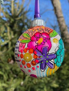 a colorful ornament hanging from a tree