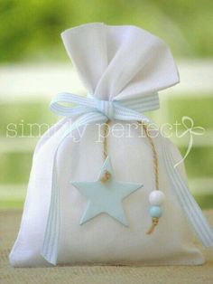 a white bag with a blue star hanging from it's side on a table