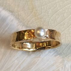 Tiny Love This is a pretty fresh water pearl ring. a simple golden brass band set with a pearl or any birthstone by choice. (RK2581) © 2011 - 2018 Artisanimpact Inc. All rights reserved. Construction & Dimensions: brass, pearl (or any other birthstone) Approximate band width: 2mm Please indicate your requested size in the order. About our jewelry All of artisanfield jewelry collection is handmade. We make the artisanfield designs from a goldfilled wire. *If, for any reason, you are not compl Fresh Water Pearl Ring, June Birthstone Ring, Freshwater Pearl Ring, Brass Band, Ring Stacking, June Birthstone, Personalized Rings, Brass Ring, Ring Dainty