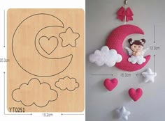 an image of a baby's crib with clouds and hearts hanging from it