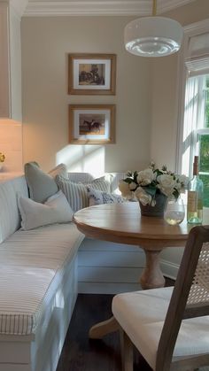 a living room filled with furniture next to a table and chairs in front of a window