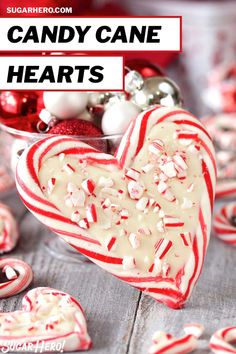 candy cane hearts in a glass bowl with white frosting and sprinkles