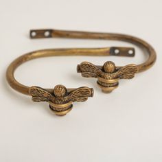 two brass bracelets with birds on them