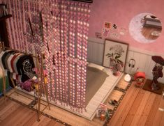 a bathroom with pink walls and wooden floors, decorated in polka dot curtains on the shower curtain