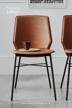 two brown chairs sitting next to each other