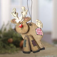 a wooden reindeer ornament hanging from a string