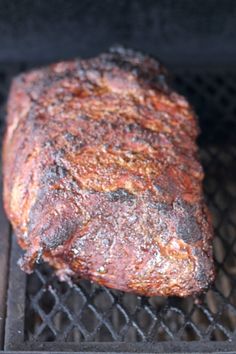 a piece of meat is cooking on the grill