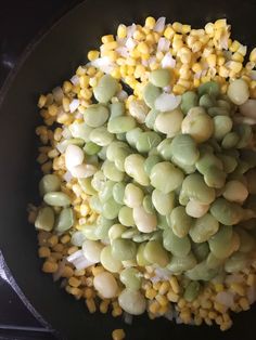 corn and other vegetables are mixed together in a skillet on the stove, ready to be cooked