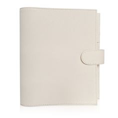 a white leather notebook with a clipping on the front and side, open to reveal an empty page