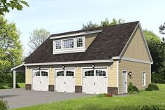 a two car garage with three windows on the top floor and an attached carport