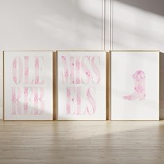 three pink and white art pieces on a wooden floor