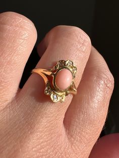 Selling a collection of vintage to antique rings. Many more coming soon - thanks for stopping by!  : ) ABOUT: Unique form to this beautifully colored angel skin coral ring.  The smooth oval pale pink coral is accented by single cut diamonds above and below with scalloped gold work giving it an ornate appearance like a tiara ring.  Low profile, so pretty!  I'm not sure when this was made.  It is at least vintage, possibly older but it doesn't look like the fabrication is as old as many of my Vict Heirloom Pink Jewelry With Center Stone, Pink Round Heirloom Jewelry, Heirloom Pink Ring With Center Stone, Heirloom Pink Gemstone Ring, Heirloom Pink Promise Ring, Classic Pink Jewelry With Rose Cut Diamonds, Antique Pink Jewelry For Formal Occasions, Classic Pink Rose Cut Diamond Jewelry, Formal Antique Pink Jewelry