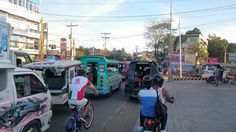 people riding bikes and cars on a city street