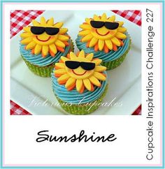 three cupcakes decorated with sunflowers and sunglasses on a white square plate