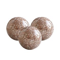 three brown and white balls sitting on top of each other