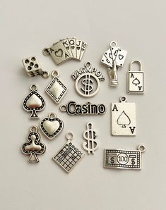 14Pc Lg Casino Charms: - Includes 14 charms - Designs are random mix - Material is alloy - Color is silver Charm designs are a random mix and may not be exactly as pictured (sometimes I need to substitute a style or two). Use these Vegas games beads and charms for jewelry making and more, some ideas are: - Necklaces - Earrings - Bracelets - Mixed-Media Crafts - Party Decor - Hair Accessories  - Billiards themed crafts **Products that are jewelry supply small parts may pose a choking hazard and s Cheap Themed Silver Charm Necklaces, Adjustable Themed Charms Jewelry, Themed Silver Jewelry With Charms, Casino Jewelry, Themed Metal Charm Bracelet, Casino Theme Necklace, Vegas Theme, Mixed Media Crafts, Color Kit