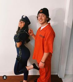 a man and woman dressed up in costumes posing for the camera, with one wearing an orange prison uniform