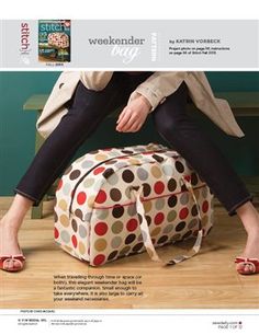 a woman sitting on top of a polka dot bag