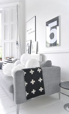 a living room filled with furniture and white walls