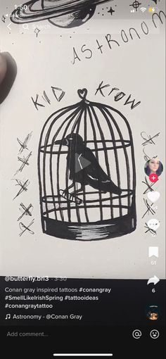 someone is holding up a piece of paper with a bird in a cage on it