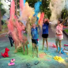 some kids are playing with colored powder in the street