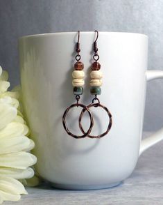 Rustic boho earrings, featuring white howlite and glazed ceramic beads, copper ring dangle and accents, and nickle-free antique copper finish ear wires. Handmade in the USA, ready to ship. These are one of my favorite new designs, and I had to claim the first pair for myself. They are so lightweight you might forget you're wearing them - perfect for all your adventures. - Speckled acrylic focal bead with faded finish wood beads, copper accents and dangles - Length: approx. 2 ½ inches (7 cm) from Fall Earring Ideas, Bohemian Earrings Diy, Fall Jewelry Ideas, Handmade Earrings Ideas, Handmade Earrings Diy, Boho Earrings Diy, Boho Jewelry Diy, Earrings Handmade Boho, Fiber Necklace