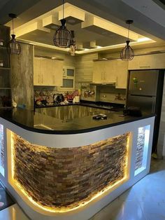 a kitchen with an island made out of bricks and lights on the counter top is lit up at night