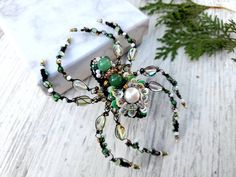 a close up of a spider on a table with beads and other things around it