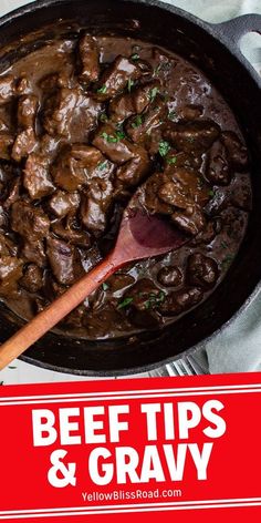 beef tips and gravy in a skillet with a wooden spoon on the side