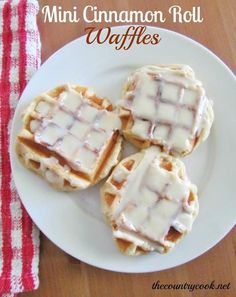 mini cinnamon roll waffles with icing on a white plate next to a red and white checkered napkin