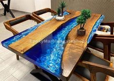 a wooden table with blue water in the center and two plants on top of it