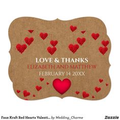 save the date card with red hearts on brown paper and hanging from strings, in front of a white background